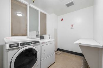 Laundry room with washing machine at Grand Central Market Apartments, Los Angeles, CA